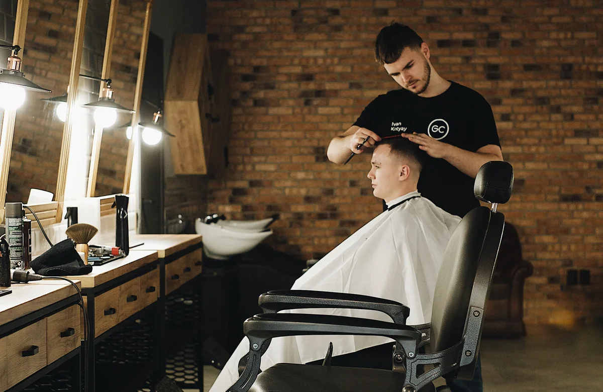 Barber cutting a client’s hair in a contemporary shop, used as the preview for the modern barbershop template